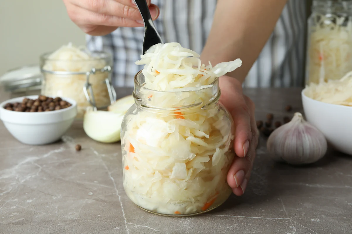 Une personne qui pet une choucroute dans un bocal
