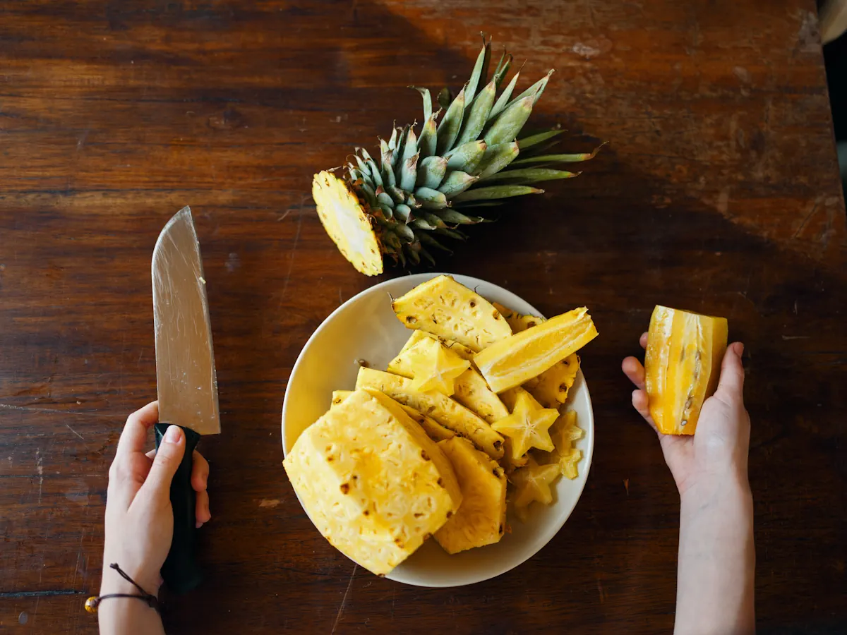 Une personne qui coupe un ananas
